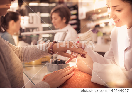 Nail technicians performing manicure 40344007