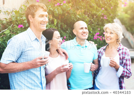 Mature couples walking and drinking coffee on holiday 40344183
