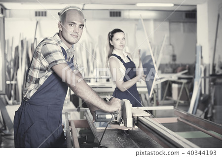 Professional workman is ready to work on circular saw in assembl 40344193