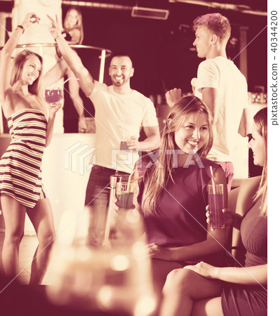 females friends with cocktail talking in the club on party females friends with cocktail talking in the club on party 40344200