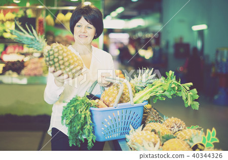 Adult female taking pineapples with basket Adult female taking pineapples with basket 40344326