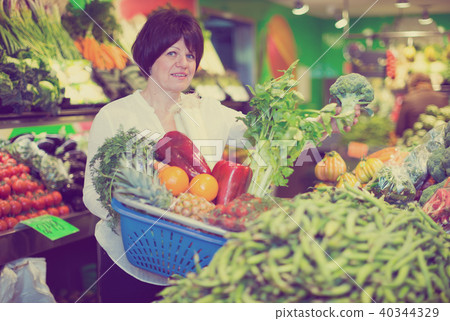 Mature woman buying fresh vegetables Mature woman buying fresh vegetables 40344329