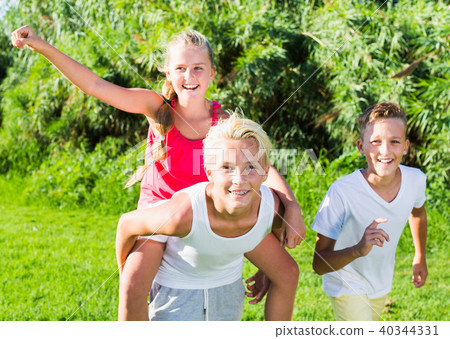 Happy children running together outdoors Happy children running together outdoors 40344331