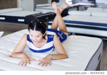 Female is lying on bed and posing playfully 40344343