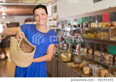 Woman displayed bag with nuts Woman displayed bag with nuts 40344345