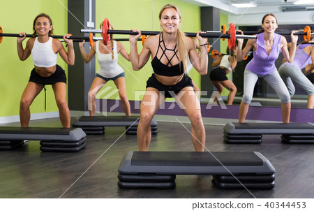 athletic girls during workout in gym with barbell athletic girls during workout in gym with barbell 40344453