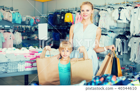 Woman and girl are standing with purchases Woman and girl are standing with purchases 40344610