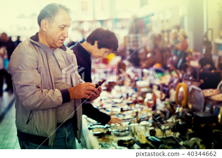 Ordinary man and woman at flea market Ordinary man and woman at flea market 40344662
