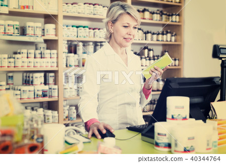 Seller checking assortment of care products in shop Seller checking assortment of care products in shop 40344764