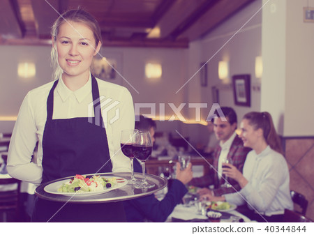 Smiling waitress with serving tray Smiling waitress with serving tray 40344844