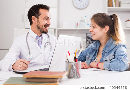 Doctor and girl with sore throat Doctor and girl with sore throat 40344858