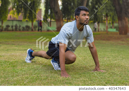 Young guy doing yoga exercise in a park 40347643