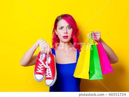 girl with colored shopping bags and gumshoes 40351724