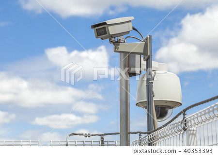 Cloudy Blue Sky And Surveillance Camera Stock Photo