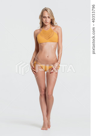 Blonde girl in swimsuit on grey background 40353796