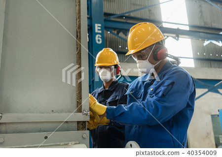Two blue-collar workers wearing protective equipment Two blue-collar workers wearing protective equipment 40354009