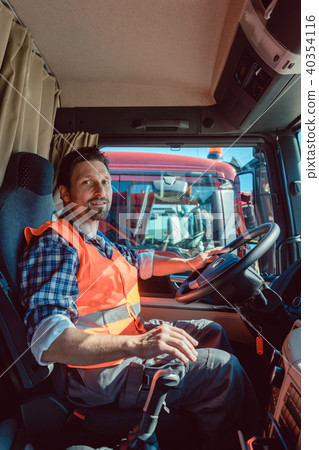 Lorry or truck driver sitting in the cabin of his vehicle Lorry or truck driver sitting in the cabin of his vehicle 40354116