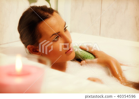 Young beautiful naked woman takes bubble bath Young beautiful naked woman takes bubble bath 40354596