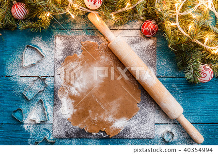 Photo of rolling pin, dough, spruce branches, garlands Photo of rolling pin, dough, spruce branches, garlands 40354994