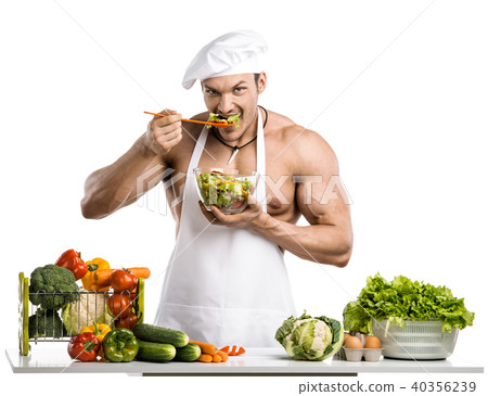 Man bodybuilder in white toque blanche and cook protective apron Man bodybuilder in white toque blanche and cook protective apron 40356239