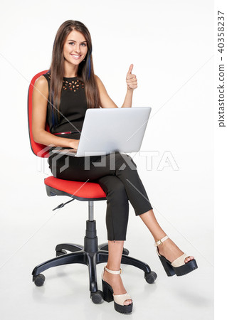 Business woman with laptop gesturing thumb up Business woman with laptop gesturing thumb up 40358237