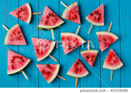Watermelon slice popslices on a blue wooden background. Freshnes Watermelon slice popslices on a blue wooden background. Freshnes 40359086