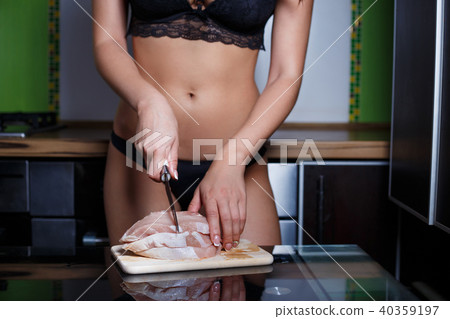 Pretty lady housewife in lingerie in her kitchen 40359197