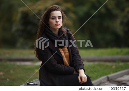 Young woman wearing stylish checkered coat and knitted sweater s 40359517