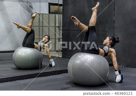 Young Asian athlete woman doing pilates exercises with exercise Young Asian athlete woman doing pilates exercises with exercise 40360121