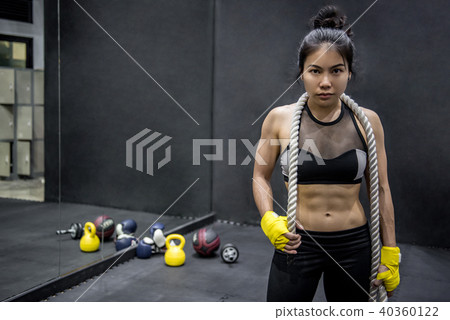Young gymnast woman posing with gymnastics rope Young gymnast woman posing with gymnastics rope 40360122