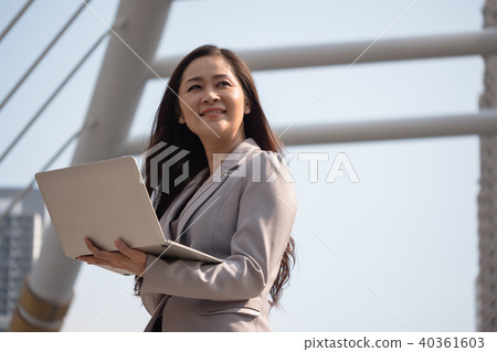 Portrait of Asian business woman holding laptop Portrait of Asian business woman holding laptop 40361603