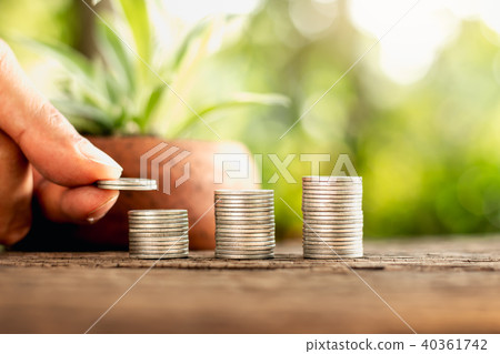 Three rows of coins placed on the old wooden floor Three rows of coins placed on the old wooden floor 40361742
