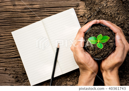 Two men's hands are putting seedling bags. Two men's hands are putting seedling bags. 40361743