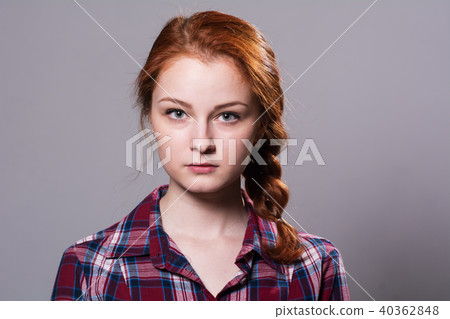 Portrait of a young red-haired girl in a plaid  40362848