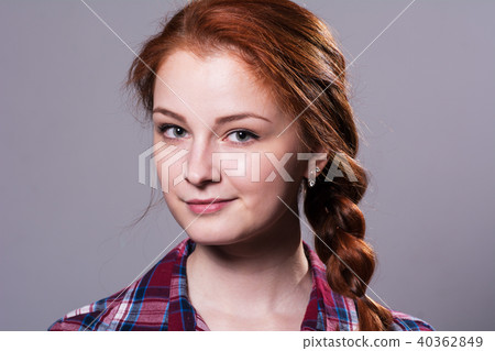 Portrait of a young red-haired girl in a plaid  40362849