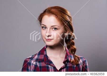 Portrait of a young red-haired girl in plaid shirt Portrait of a young red-haired girl in plaid shirt 40362850