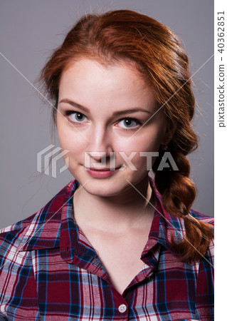Portrait of a young red-haired girl in a plaid  40362851