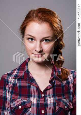 Portrait of a young red-haired girl in a plaid  40362852