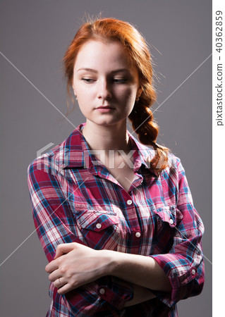 Young red-haired girl with a pigtail in a plaid  40362859