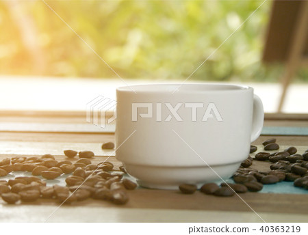 cup of coffee and beans with blurred green leaf cup of coffee and beans with blurred green leaf 40363219