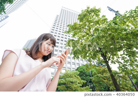 A woman using a smartphone A woman using a smartphone 40364050