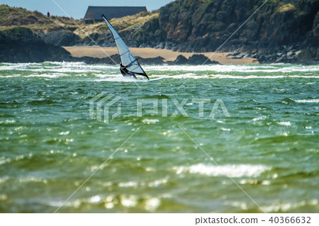 Wind surfer enjoys the beach at Newborough Warren with the Island of Llanddwyn in the background Wind surfer enjoys the beach at Newborough Warren with the Island of Llanddwyn in the background 40366632