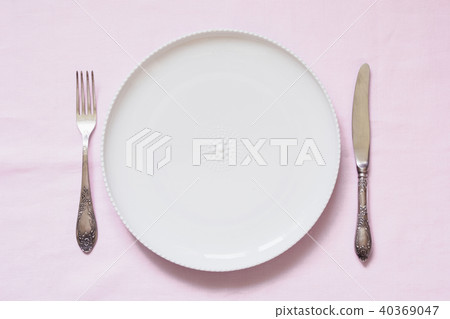 Table place setting on pink linen tablecloth.  Table place setting on pink linen tablecloth.  40369047