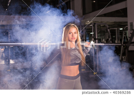 sport, fitness, training and happiness concept - sporty woman with barbell in gym sport, fitness, training and happiness concept - sporty woman with barbell in gym 40369286