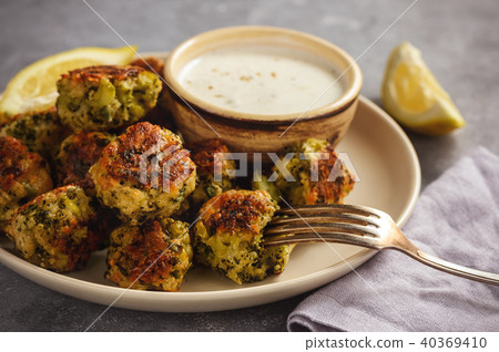 Baked broccoli cheese balls with garlic dip. 40369410