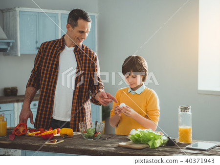 Son learning from father preparing salad Son learning from father preparing salad 40371943