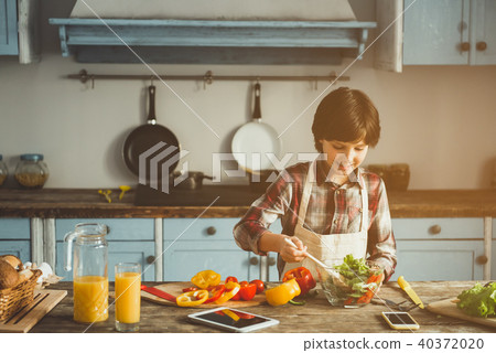 Little boy enjoying cooking at home Little boy enjoying cooking at home 40372020