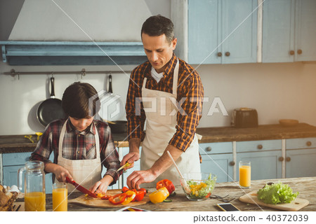 Little boy assisting his dad in cooking Little boy assisting his dad in cooking 40372039