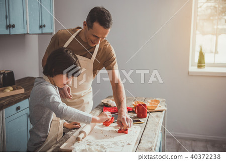 Dad and boy doing cookies with molds 40372238