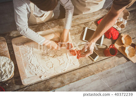 Relatives cutting figurines from the dough 40372239
